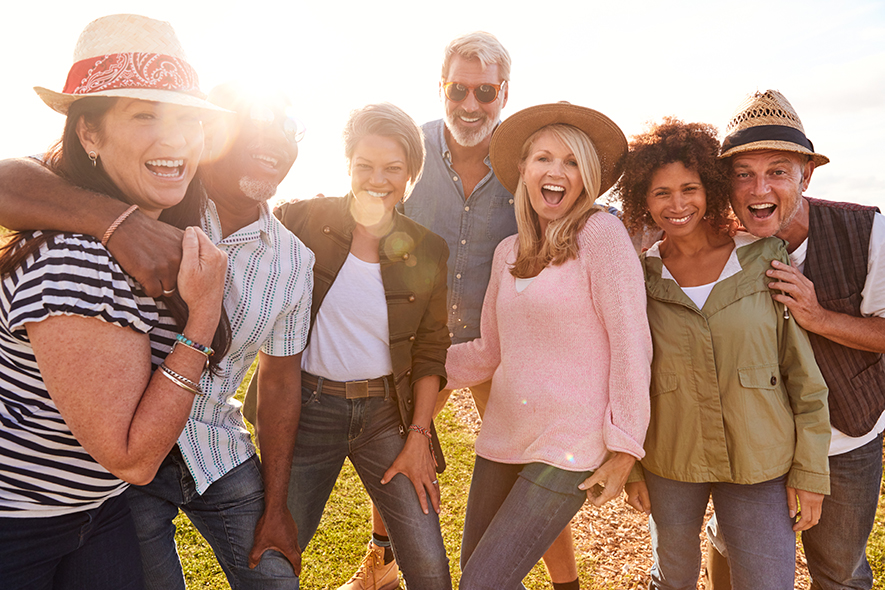 Group of mature, diverse friends smiling.