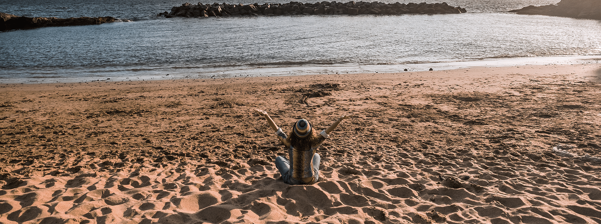 Woman sitting on the beach.