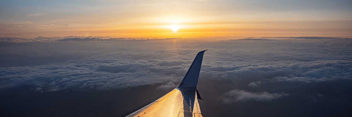 Sunrise view out of an airplane window.